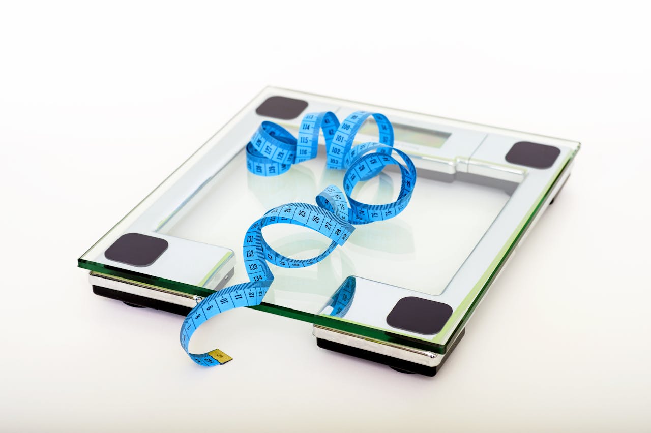 Blue Tape Measuring on Clear Glass Square Weighing Scale