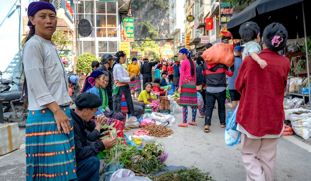 Bustling street market scene with colorful clothing and local trade.