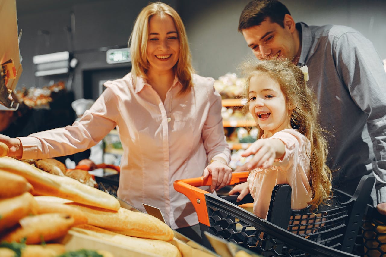 Happy family with a child shopping in a supermarket, smiling and bonding.