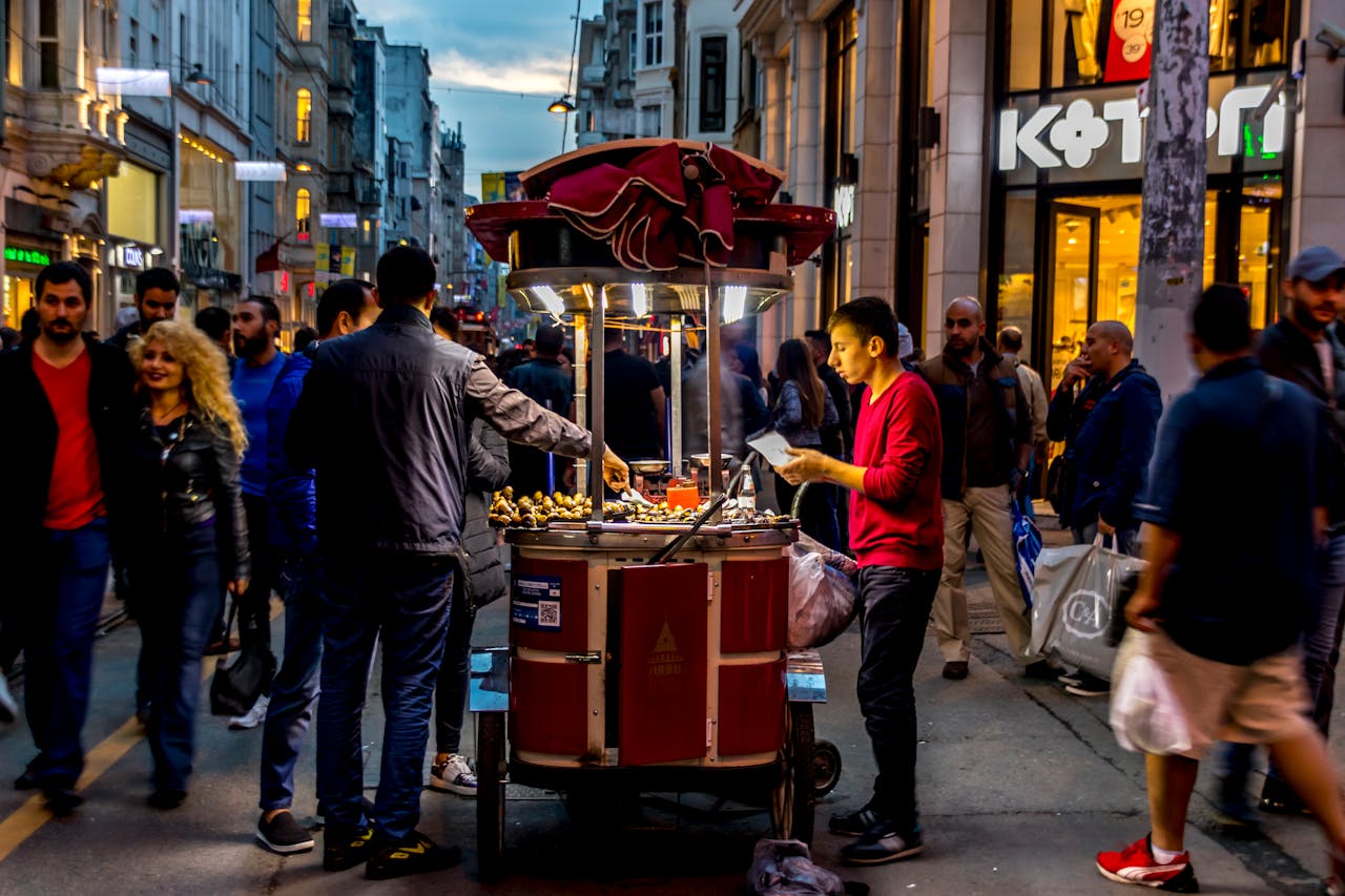 projects-header A vibrant street food vendor serving customers in a busy urban setting, capturing the night ambiance.